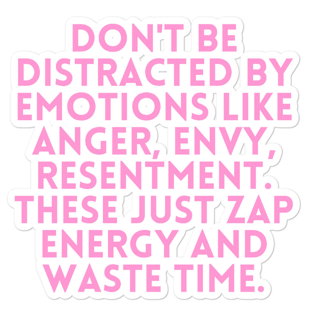 Close-up of pink sticker reading “DON’T BE DISTRACTED BY EMOTIONS LIKE ANGER, ENVY, RESENTMENT.”