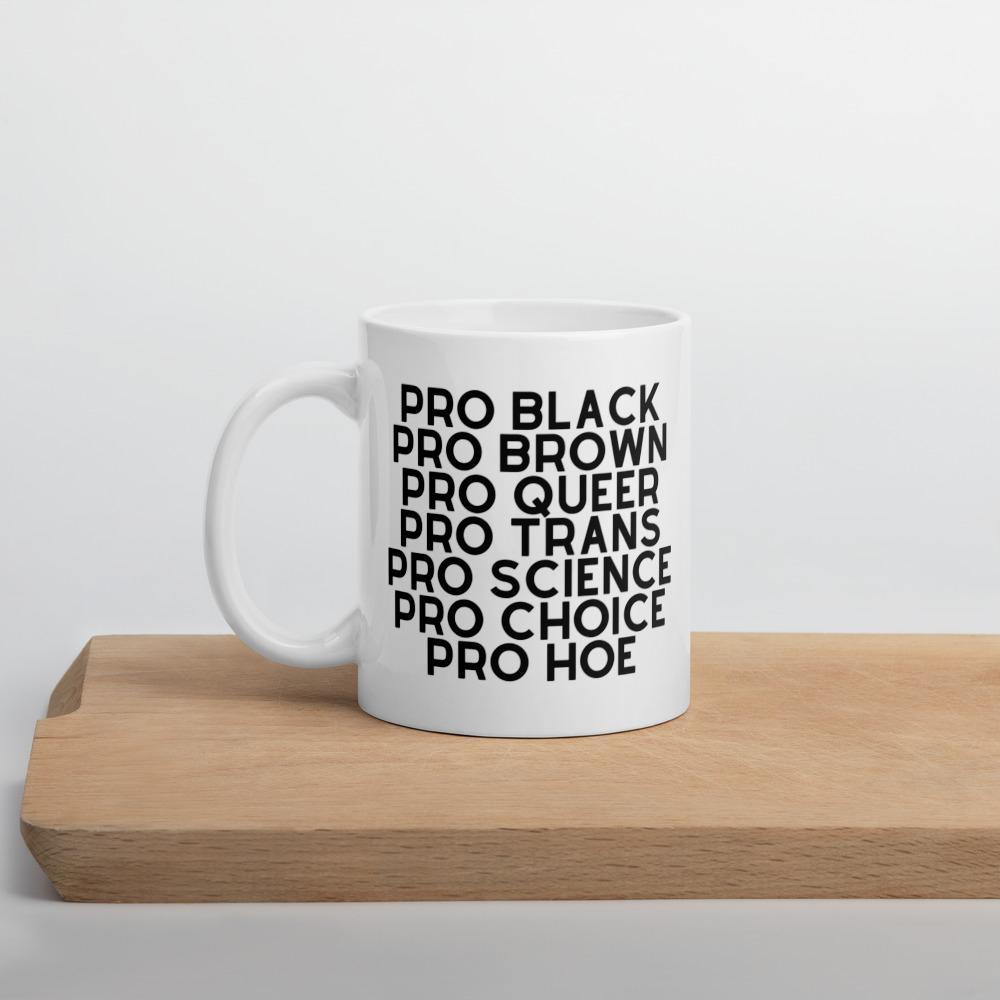 White mug printed with “PRO BLACK PRO BROWN PRO QUEER PRO TRANS PRO SCIENCE PRO CHOICE PRO HOE”