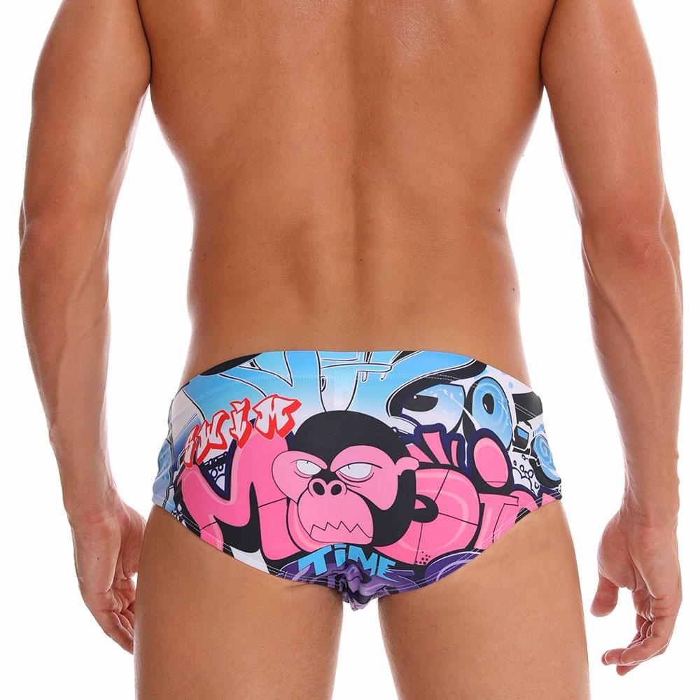 Rear view of colorful swim briefs featuring a pink cartoon gorilla and graffiti-style graphics