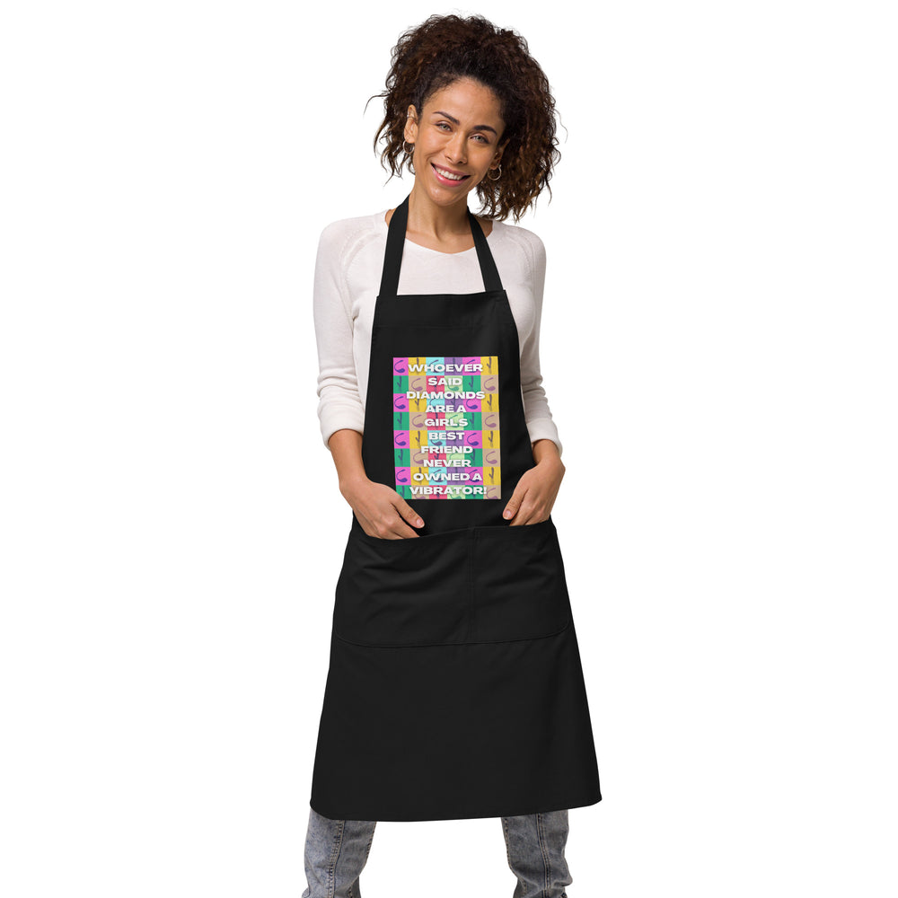 Front view of a model wearing a black apron with a colorful vibrator-themed slogan panel