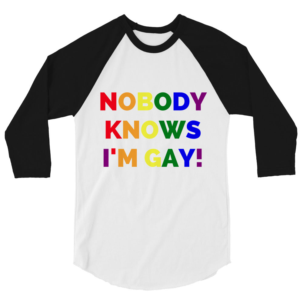 Front view of a white raglan shirt with black three-quarter sleeves and rainbow text, “NOBODY KNOWS I'M GAY!”