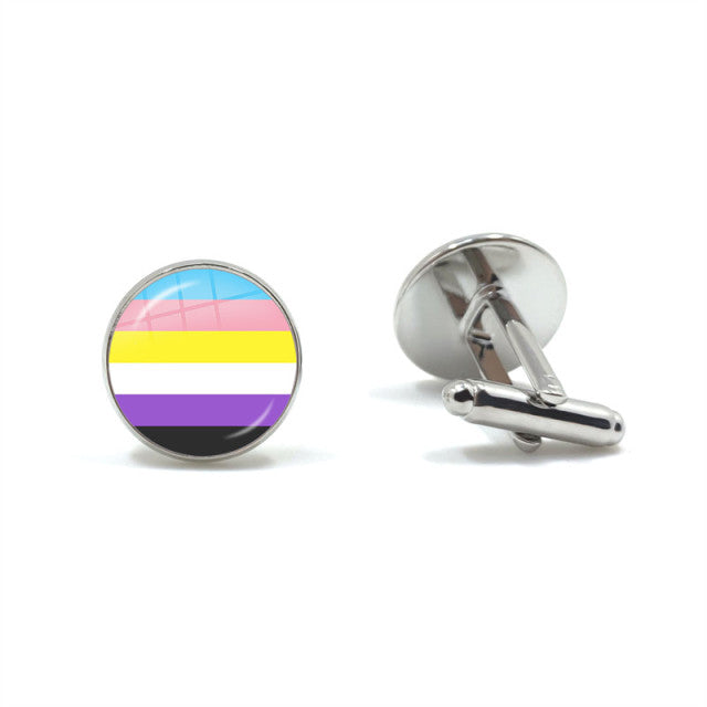 Pair of silver cufflinks, one showing a nonbinary pride flag in a round face