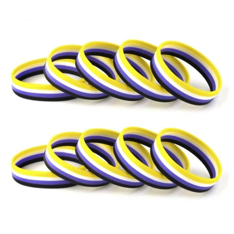 Five non-binary pride rubber wristbands in yellow, white, purple, and black stripes