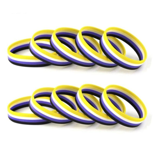 Five non-binary pride rubber wristbands in yellow, white, purple, and black stripes