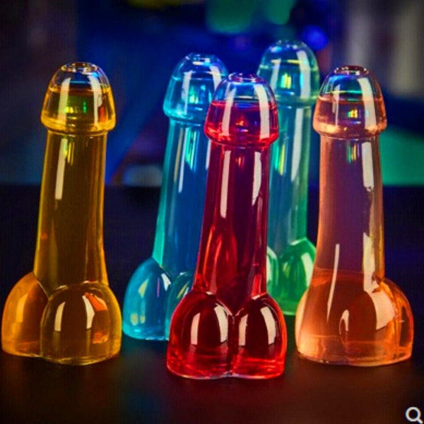 Close-up of colorful penis-shaped shot glasses in amber, blue, red, green, and pink