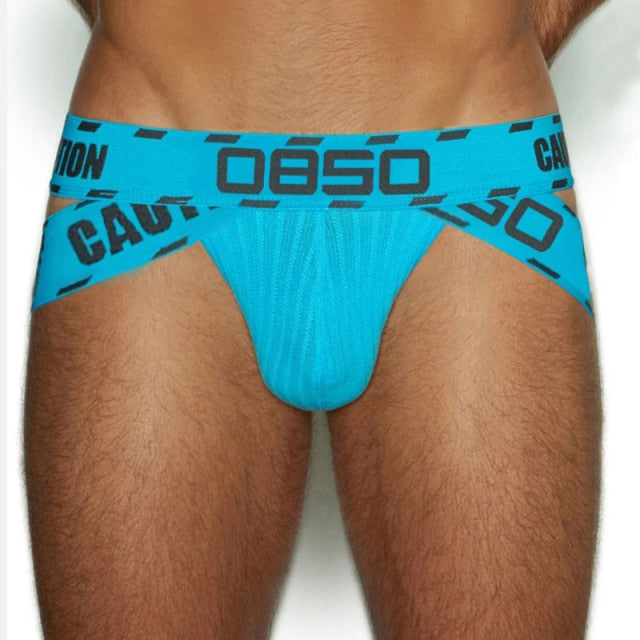 Front view of a turquoise jockstrap with a black OBO waistband and caution-style lettering