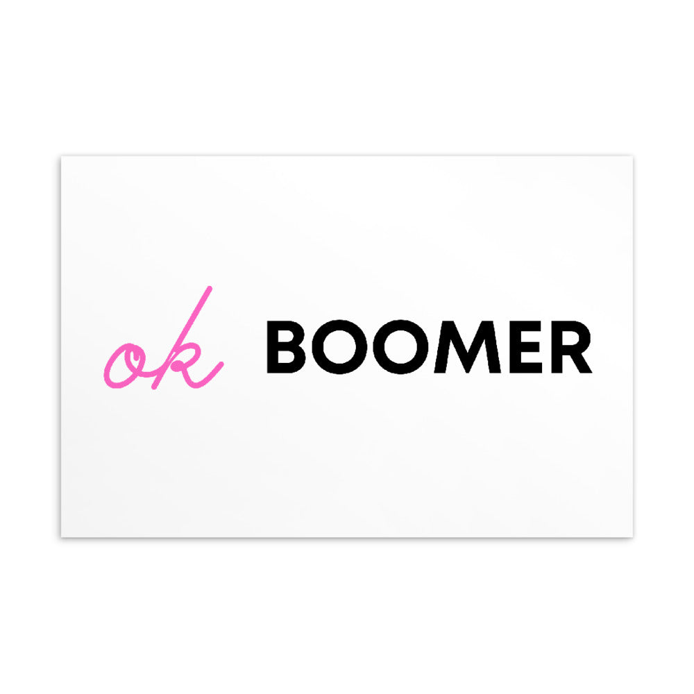 White postcard featuring pink script initials and the black word “BOOMER”
