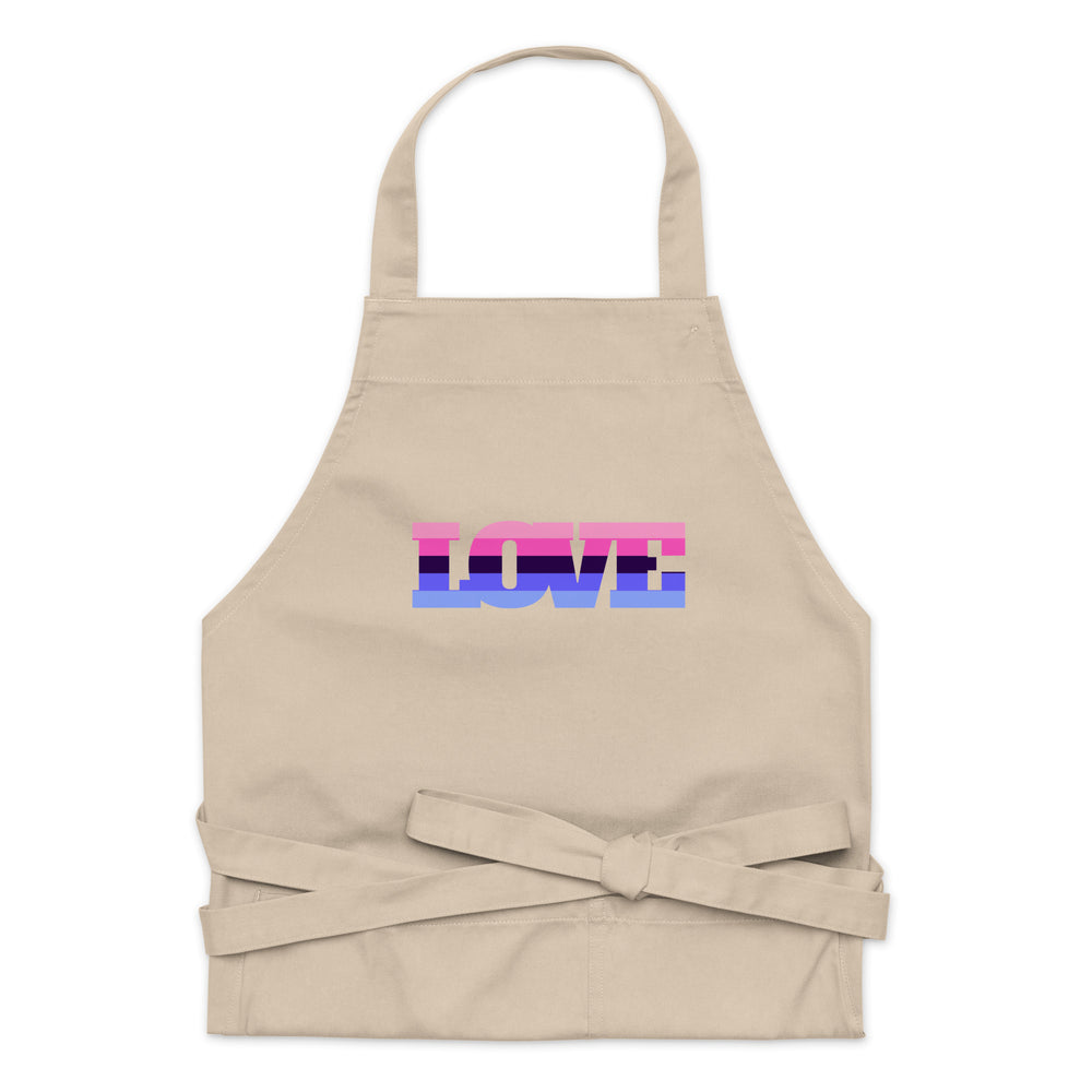 Flat-lay beige apron with a pink, purple, and blue “LOVE” graphic and waist ties
