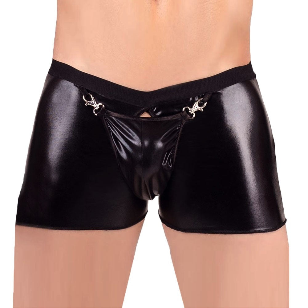 Front view of a model wearing black shiny PU leather open-crotch boxer shorts