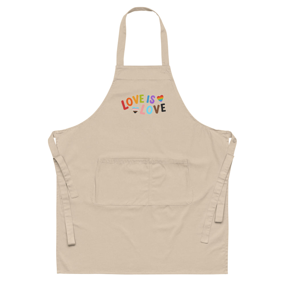 Front-view beige apron with rainbow “LOVE IS LOVE” lettering and two heart motifs