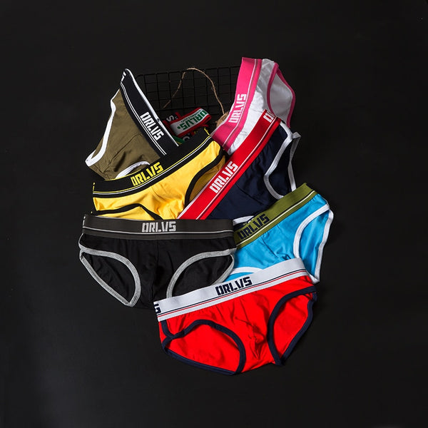 Flat lay of colorful ORLVS briefs in black, yellow, red, blue, pink, and olive