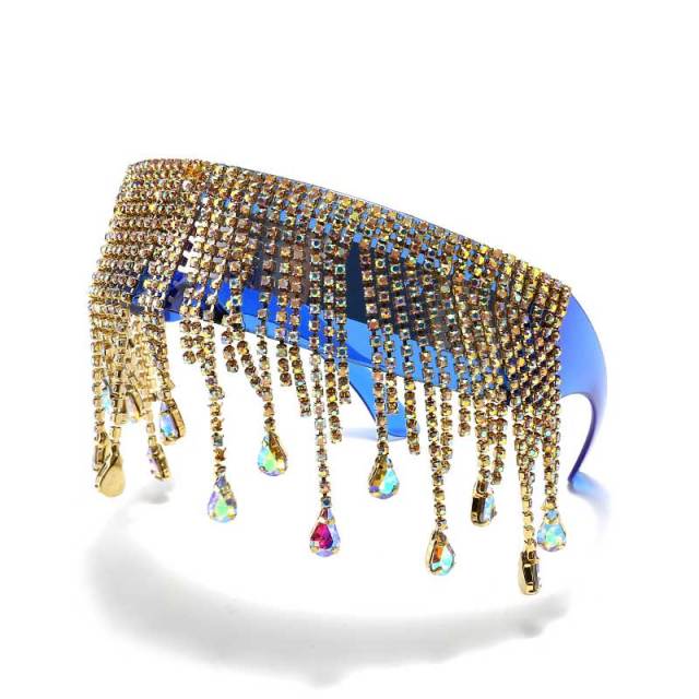 Close-up of oversized crystal sunglasses with gold rhinestone tassels and multicolor teardrop gems
