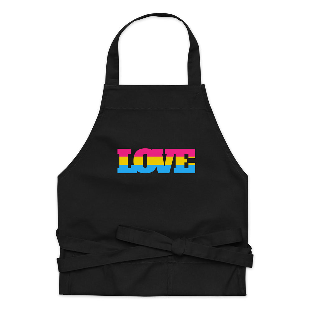 Front view of a black apron with a pink, yellow, and blue “LOVE” graphic and waist ties