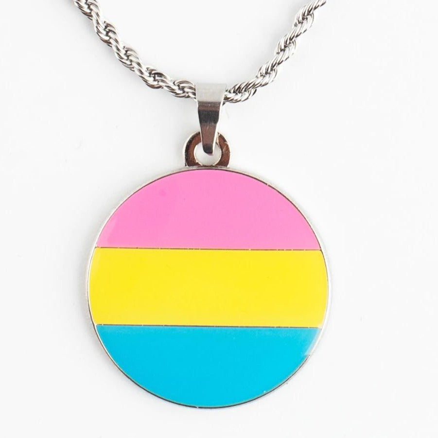 Close-up of a round pansexual pride pendant necklace with pink, yellow, and blue stripes