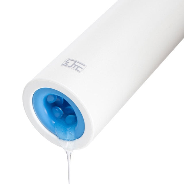 White cylindrical penis masturbator shown at an angle with a blue textured opening and lubricant dripping