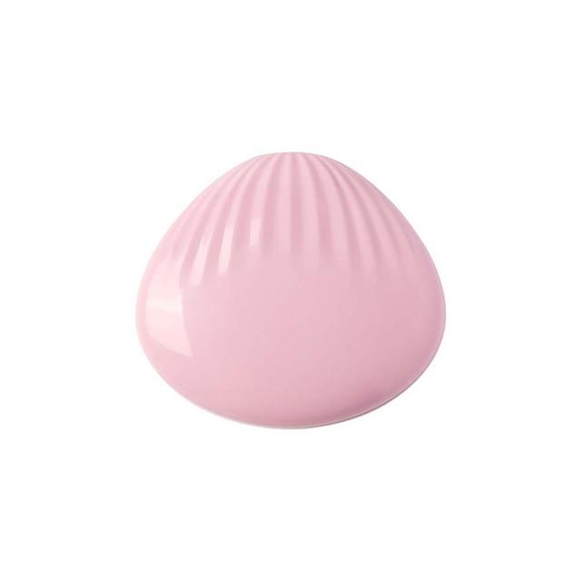 Glossy pink egg-shaped pocket rainbow projection lamp on a white background