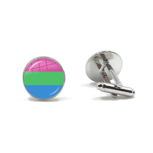 Pair of silver cufflinks, one showing a pink, green, and blue striped face