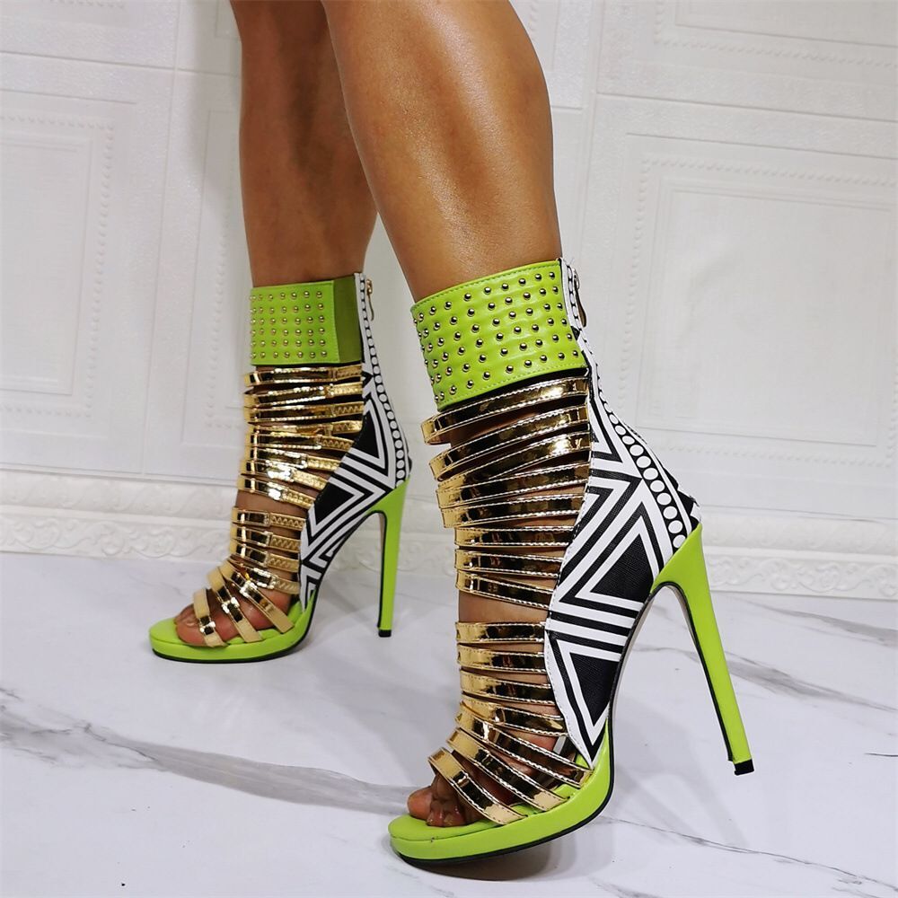 Rear-side view of neon green gladiator heels with gold straps and graphic panels