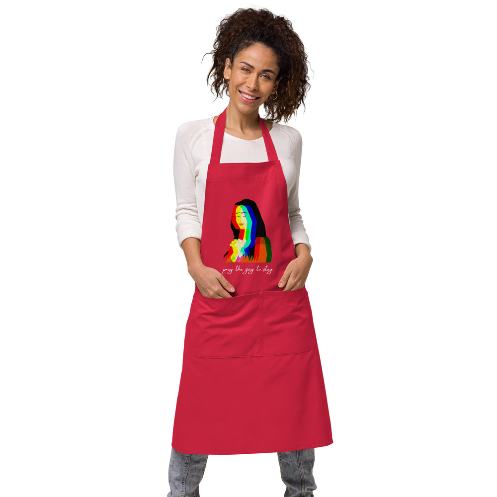 Model wearing a red apron with a rainbow portrait and “pray the gay to stay” text