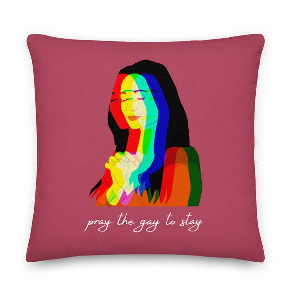 Square burgundy pillow with a rainbow-toned praying couple and “pray the gay to stay” text
