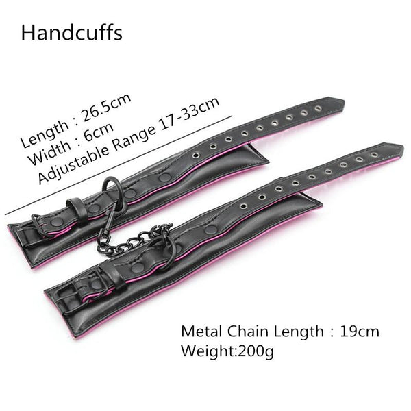 Black leather-look handcuffs with pink trim, metal chain, and adjustable buckle straps