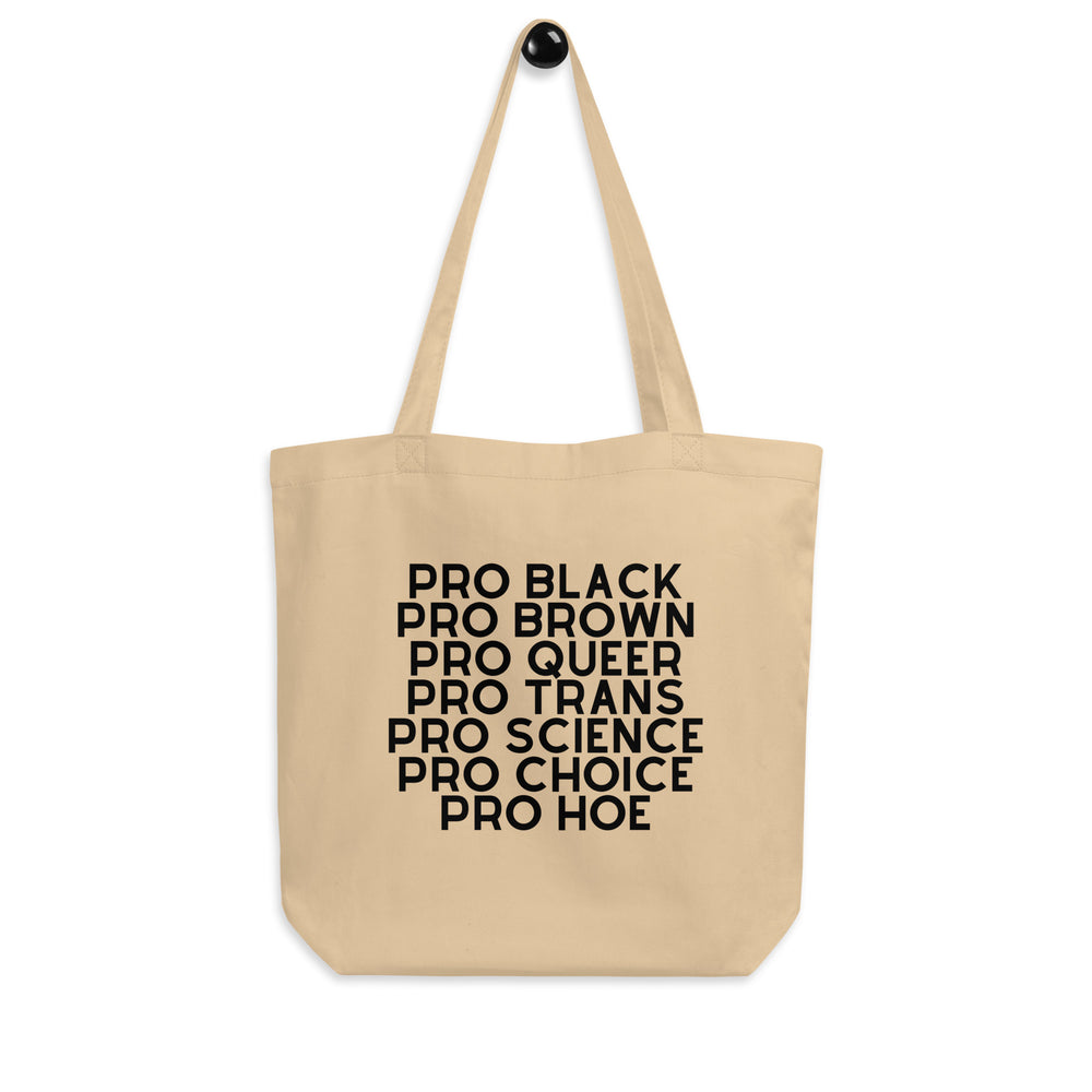 Natural canvas tote bag printed with stacked black text: “PRO BLACK,” “PRO BROWN,” “PRO QUEER,” “PRO TRANS,” “PRO SCIENCE...
