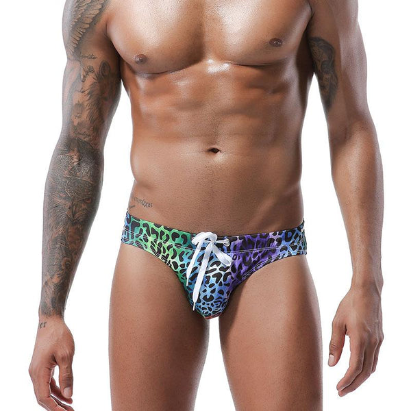 Model wearing rainbow leopard-print swim briefs with a white drawstring