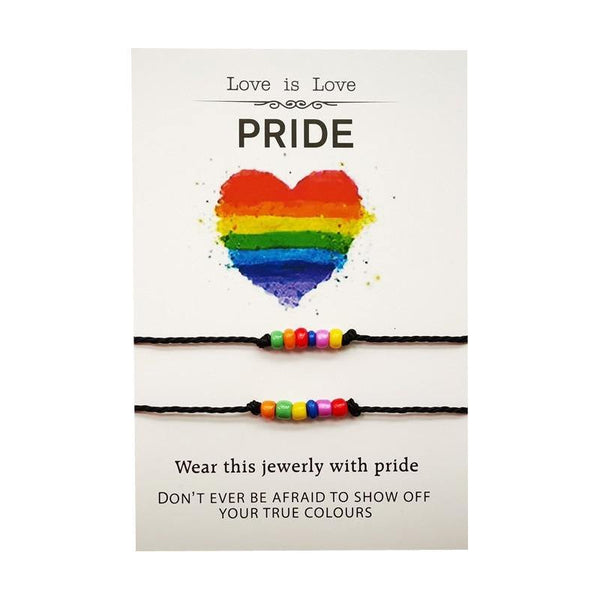 Two black cord bracelets with rainbow beads on a Pride card reading “Love is Love”