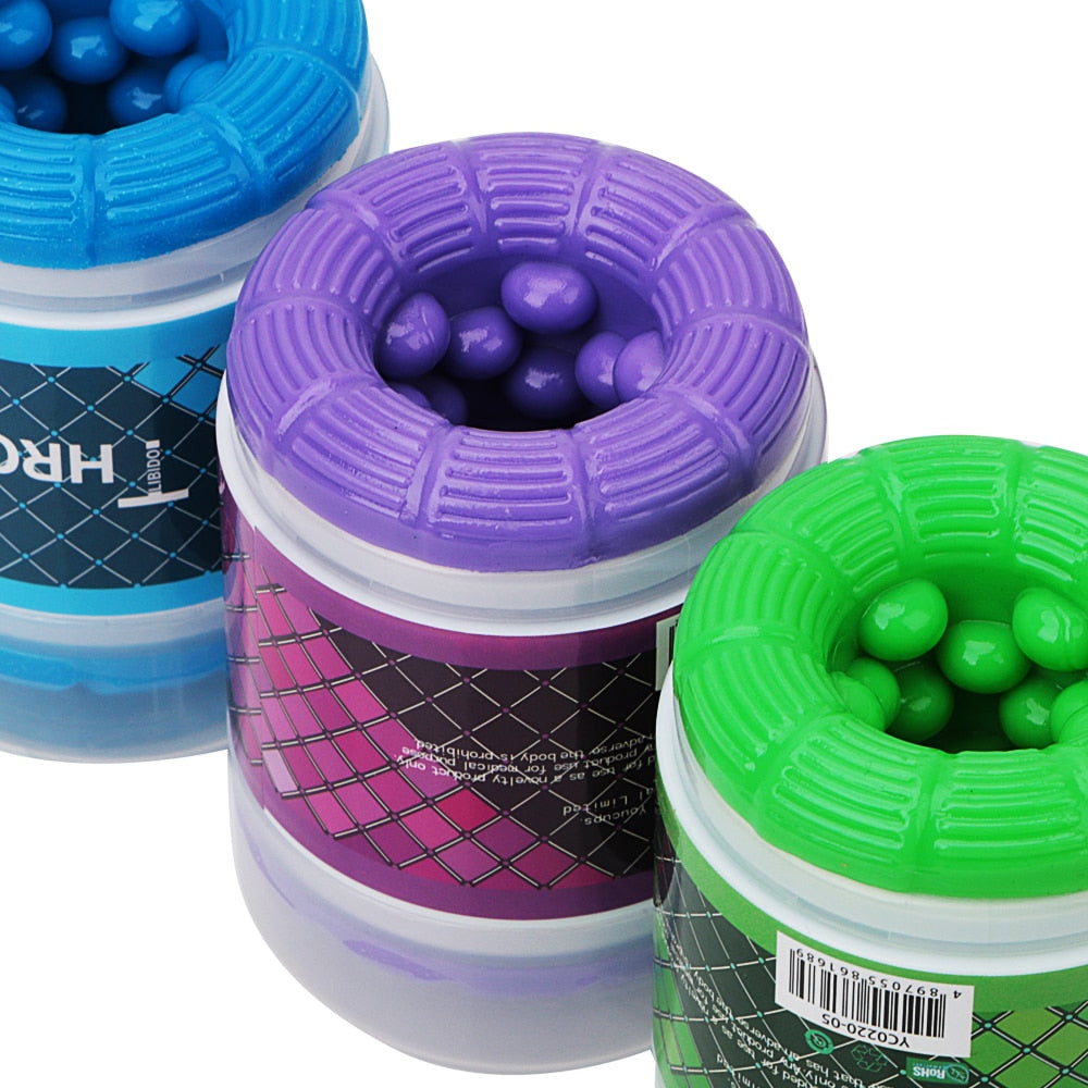Purple dual-channel male masturbator in a labeled jar, with blue and green versions behind it