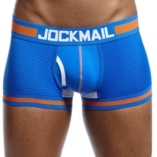 gays en boxers: Muscular person in bold blue Jockmail Mesh Boxers with orange trim, hands behind back, head cropped