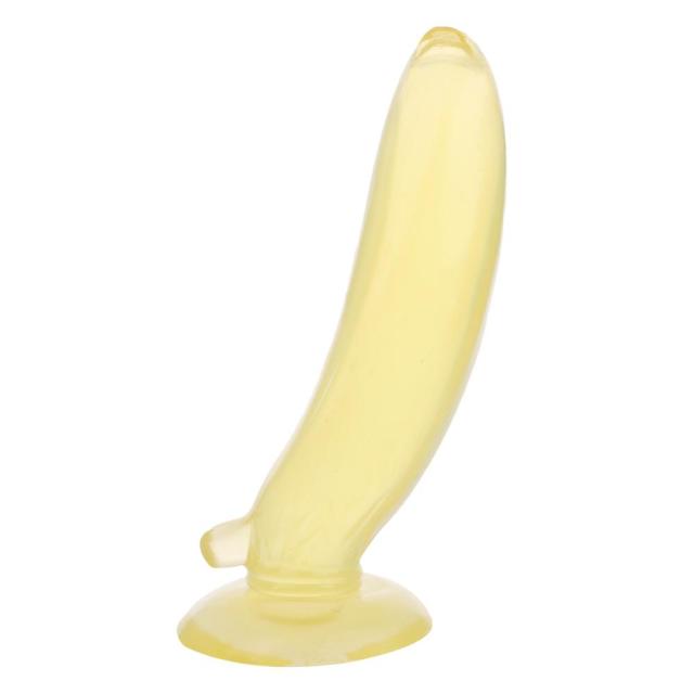 Yellow banana-shaped dildo standing on a flared suction base against a white background