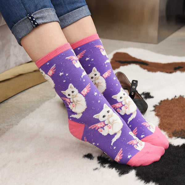 Purple crew socks with pink cuffs and flying white kitty prints, worn with rolled jeans
