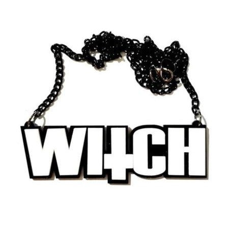 Black chain necklace with large white acrylic “WITCH” pendant