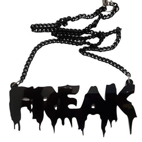 Black acrylic “FREAK” statement necklace with dripping-letter pendant and chain