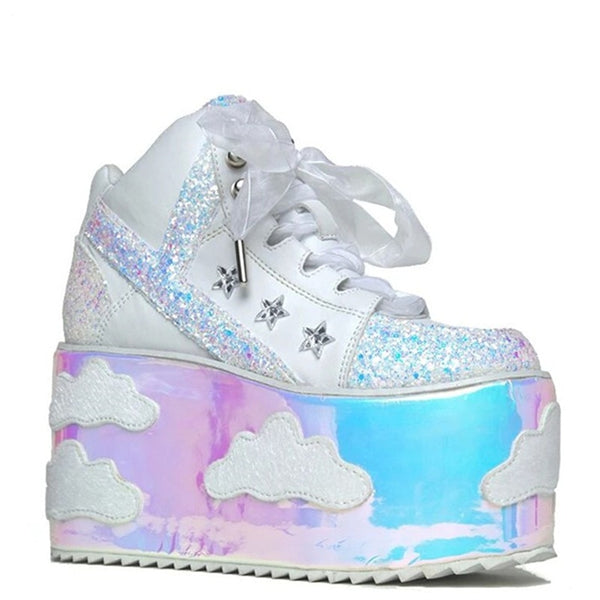 White high-platform sneakers with iridescent glitter panels, star hardware, and cloud-decorated soles