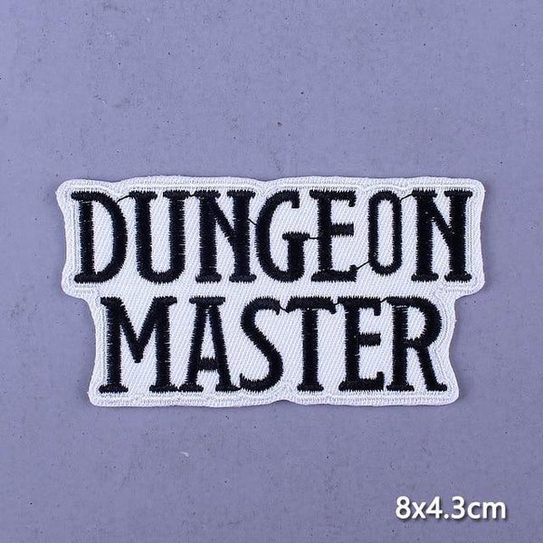 Embroidered iron-on patch reading “DUNGEON MASTER” in black on white