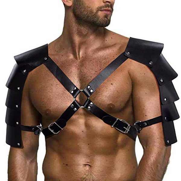 Model wearing a black gladiator chest harness with buckled straps and layered shoulder armor