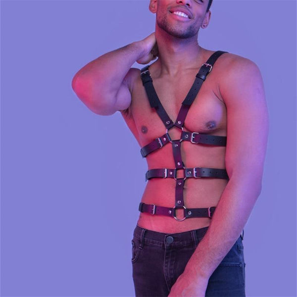 Model wearing a black leather full-body harness with buckled chest and waist straps