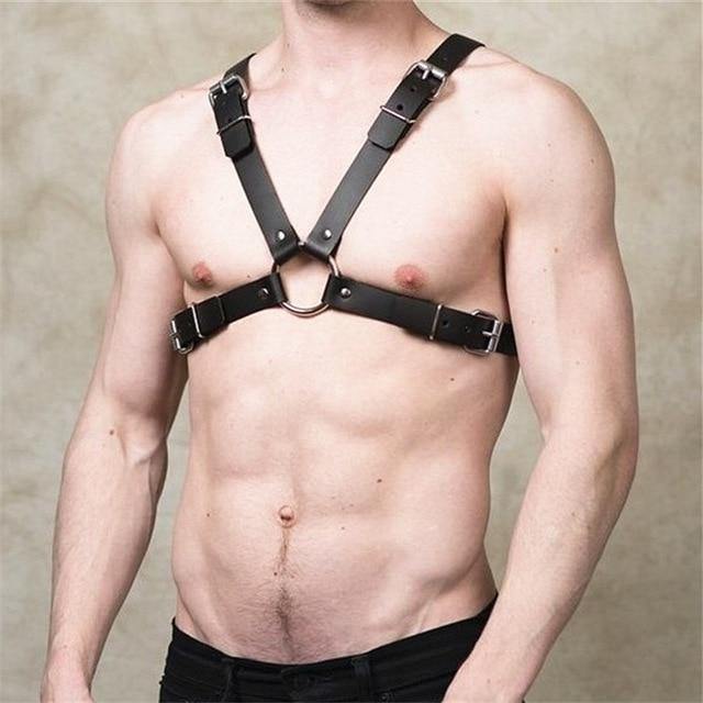 Close-up of a black four-strap leather chest harness with metal buckles and O-ring
