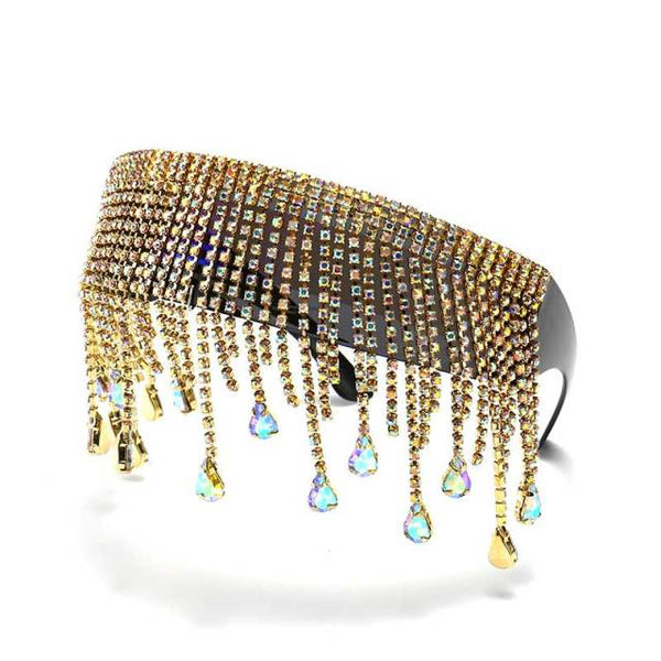 Close-up of oversized crystal sunglasses with gold rhinestone tassels and teardrop charms