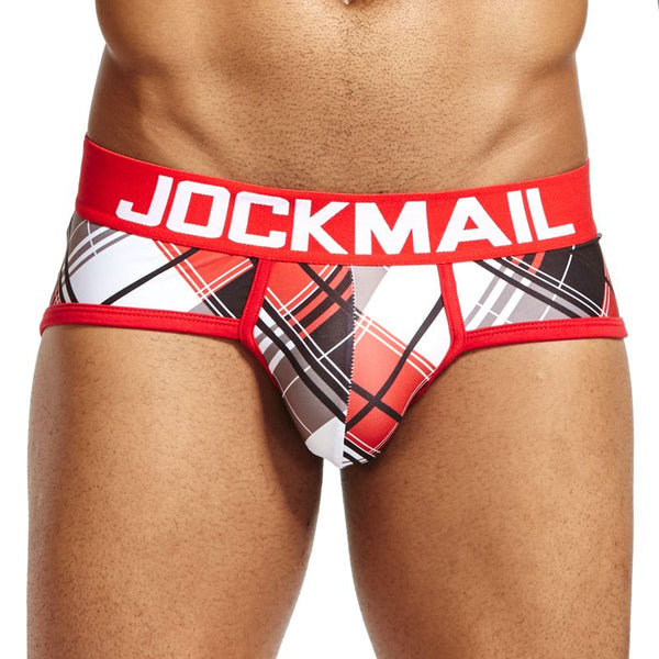 Model wearing red Jockmail briefs with a red, black, and white tartan-style geometric print