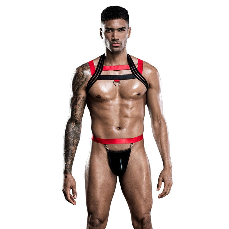Model wearing a black and red chest harness with O-ring and black pouch jockstrap