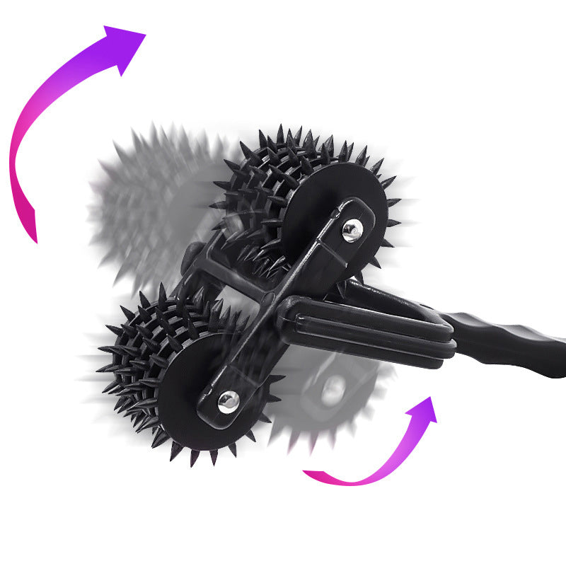 Black five-row spiked Wartenberg wheel with a textured handle, shown at an angle