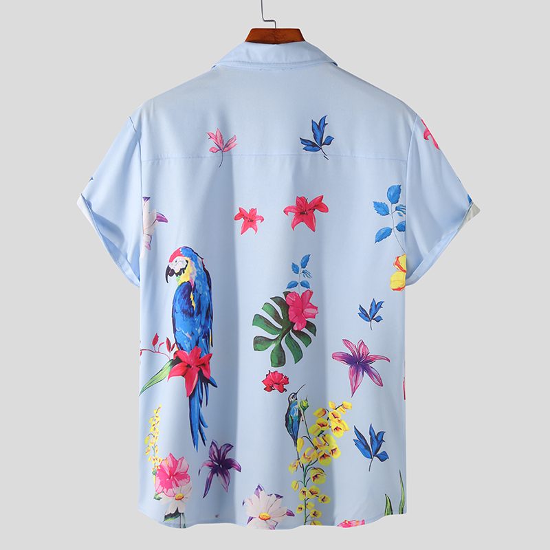 Back view of a light blue short-sleeve shirt with parrots and colorful tropical flowers