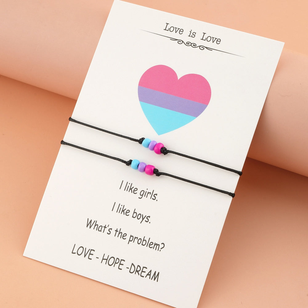 Two bisexual pride bead bracelets on a card reading “I like girls. I like boys.”