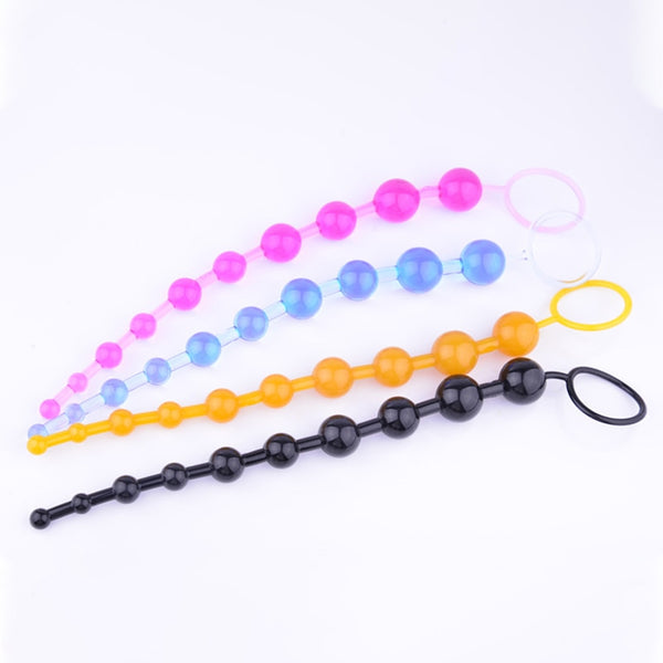 Four graduated anal bead strands in pink, blue, orange, and black, arranged on white
