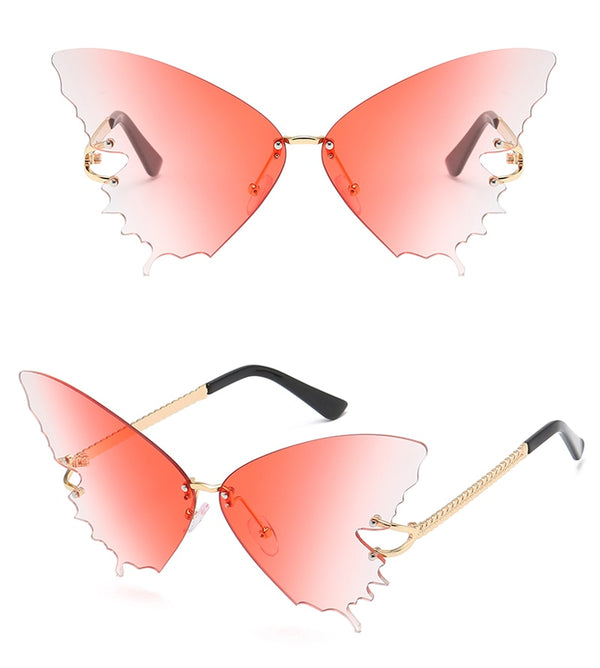 Close-up of pink butterfly-shaped rimless sunglasses with scalloped lenses and gold-tone arms