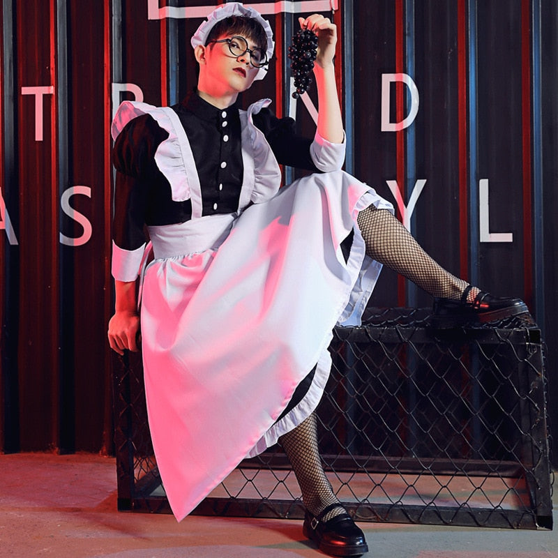 Model wearing a black-and-white French maid costume with apron, ruffles and fishnet stockings