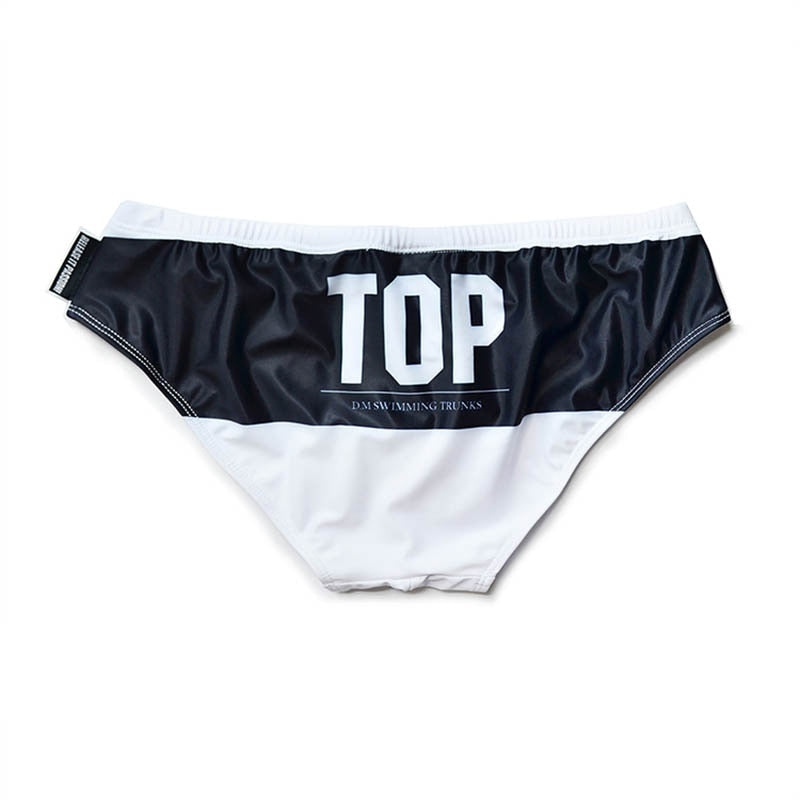 Black-and-white swim brief with a large white “TOP” logo on the front
