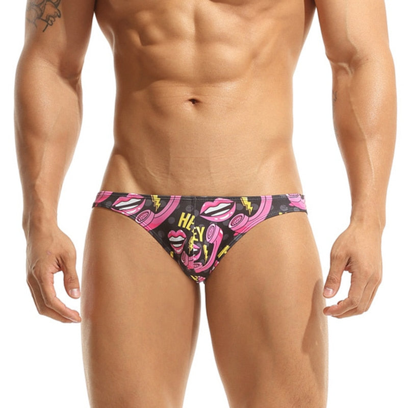 Black brief underwear with pink lips, lipstick and lightning-bolt print, worn by a model